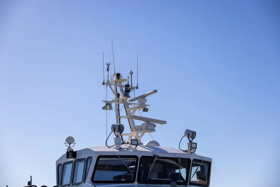 Radar and antenna mast on a vessel bridge, illustrative of AIS/tracking equipment